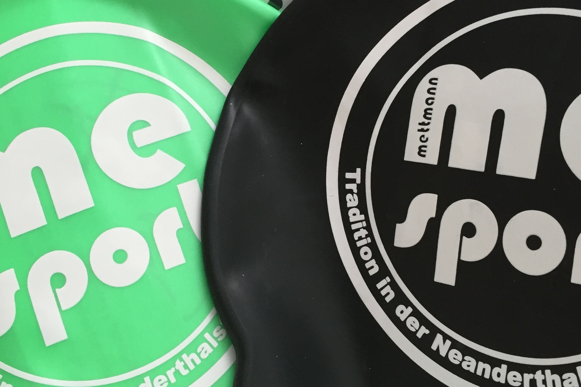 Schwimmkappen in Gr&uuml;n und Schwarz mit Hinweis auf 10 St&uuml;ck, verpackt in einer Box.