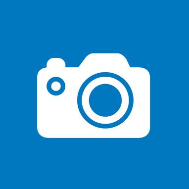 Blauer Hintergrund mit weißem Piktogramm was eine Kamera darstellt.