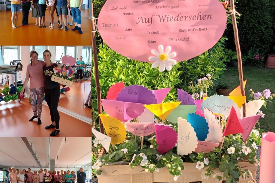 Gruppenfoto von Teilnehmern einer Veranstaltung mit einer dekorativen „Auf Wiedersehen“-Tafel und bunten Fähnchen auf Tisch.